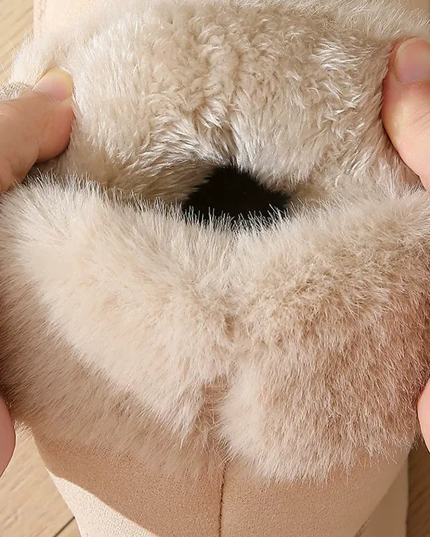 Hands pressing open the cuff to show the thick faux-fur lining