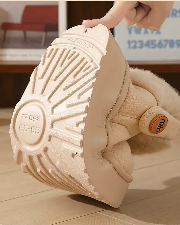 A hand bending the thick, ridged platform sole of an ivory white boot