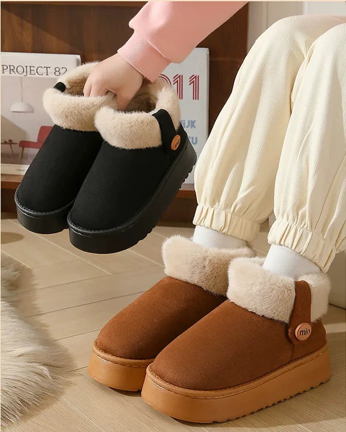 A black pair held up in one hand above a dark brown pair being worn