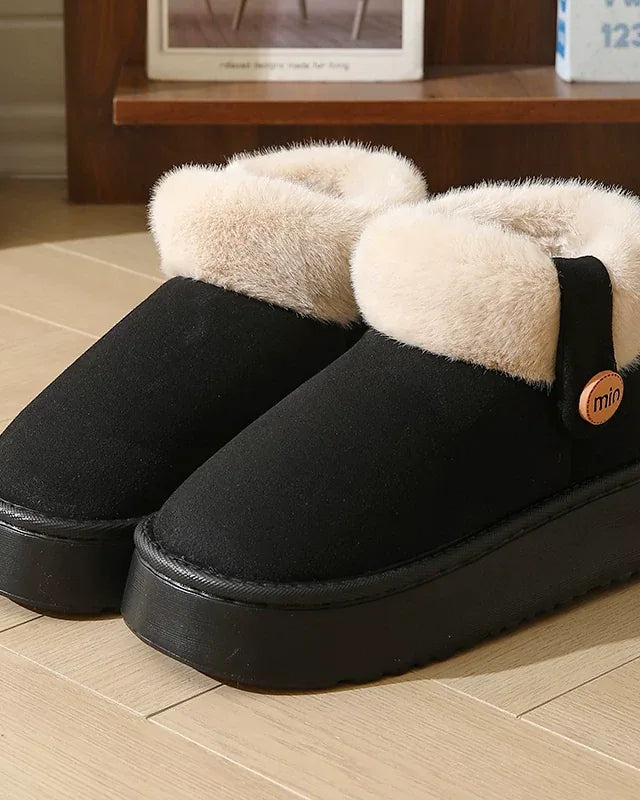 Pair of black faux-suede slipper boots with a cream cuff and a black platform sole