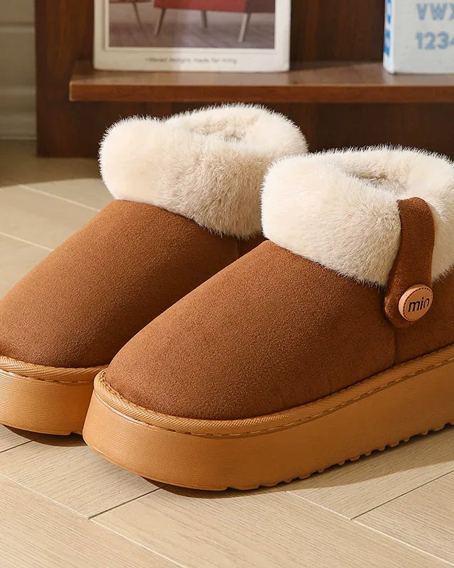 Pair of dark brown faux-suede slipper boots with a cream cuff and a tan platform sole