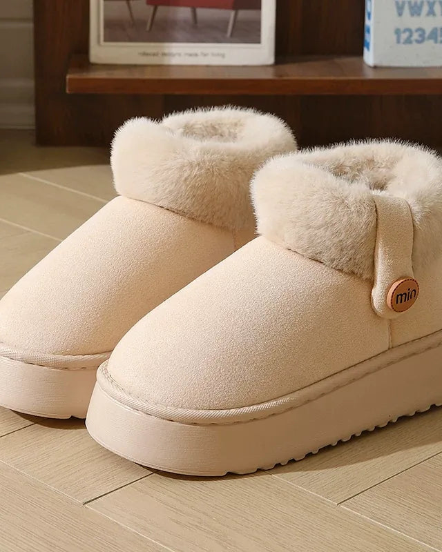 Pair of ivory white faux-suede slipper boots with a fluffy cuff and a cream platform sole