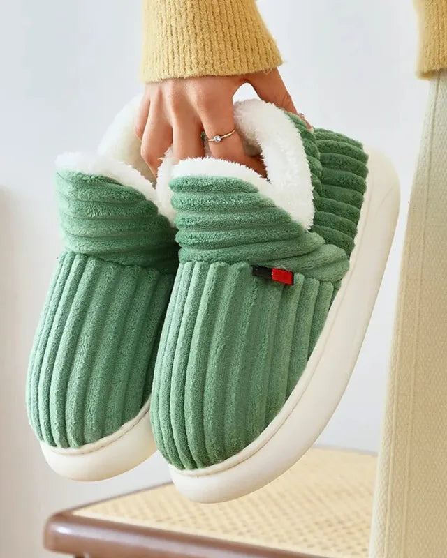 A green pair carried by the collar, showing the thick fleece lining