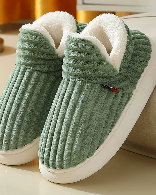 Pair of sage green ribbed plush slipper boots with a cream fleece collar and a white sole