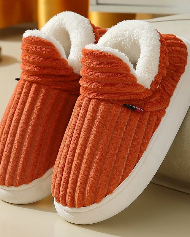 Pair of burnt orange ribbed plush slipper boots with a cream fleece collar and a white sole